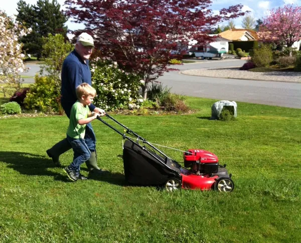 Young Matthew Hutchison with a gas-powered lawnmower in Nanaimo