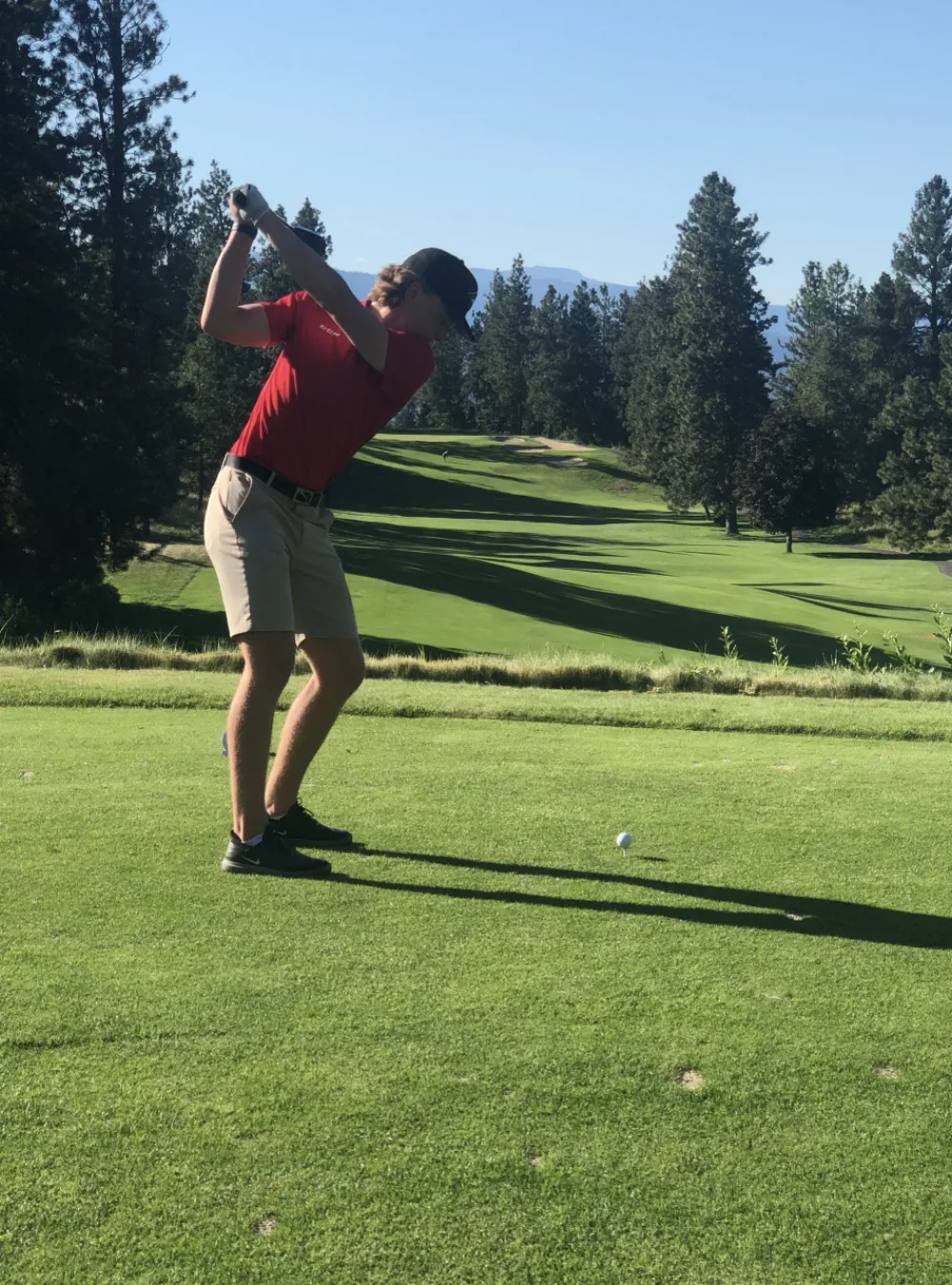 Matthew Hutchison at the top of a golf swing on a Vancouver Island golf course